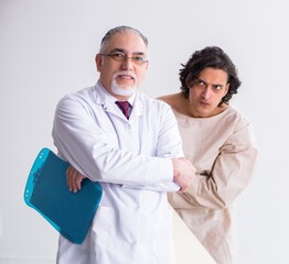 Wall Mural - Aged male doctor psychiatrist examining young patient