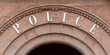 the word POLICE on a brownstone archway