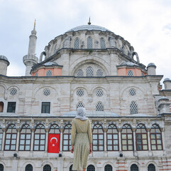 Happy attractive muslim woman near mosque in istanbul turkey posing in courtyard of mosque, religion and travel concept.