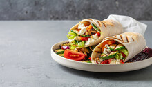 Wrap Sandwich With Grilled Vegetables And Feta Cheese On A Plate. Grey Background. Copy Space.