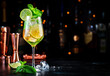 Hugo spritz alcoholic cocktail drink with dry sparkling wine or prosecco, elderflower syrup, soda, lime, mint and ice, dark bar counter background