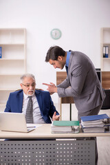 Wall Mural - Two male colleagues working in the office