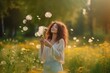 © tonstock - Illustration of Beautiful Young Woma on the field in green grass and blowing dandelion. Generative AI