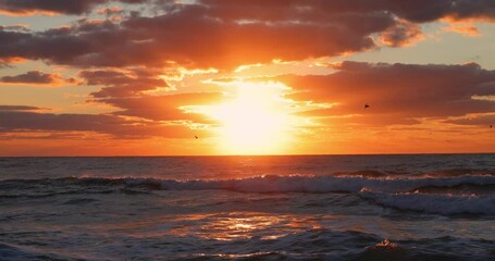 Wall Mural - tropical sunrise with dramatic clouds and sun rays over ocean waves and caribbean sea, seascape hori