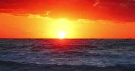 Wall Mural - tropical sunrise with dramatic clouds and sun rays over ocean waves and caribbean sea, seascape hori
