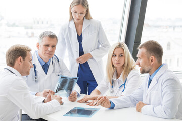 Wall Mural - Group of doctors looking at x-ray