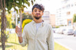 © luismolinero - Young Arabian handsome man with a bottle of water at outdoors with sad expression