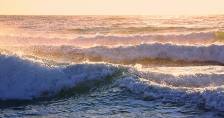 Wall Mural - colorful ocean beach sunrise with color sky and sunrays and rolling waves on the sea shore 4k video
