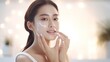 © WS Studio 1985 - Close up perfect beauty face of young beautiful Asian woman massages her face gently with fingertips. Face cream commercial advertising concept with generative ai