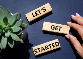Wall Mural - lets get started symbol. concept words lets get started on wooden blocks. beautiful deep blue backgr