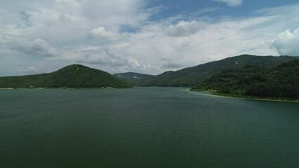 Wall Mural - lake between mountain hills aerial view. water reservoir dam panorama, nature of bulgaria 4k video