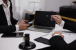 © SOMKID - Male lawyer working with contract at desk, justice and law concept.