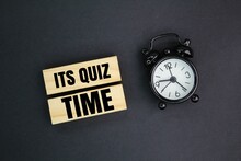 Bell And Stick Clock With The Words Its Quiz Time. The Concept Of Answering Quizzes Or Quiz Games