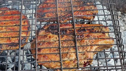 Wall Mural - Process of cooking meat in grate on fire close up

