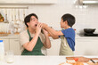 © tonefotografia - Happy Young Asian father and son eating healthy food in kitchen at home