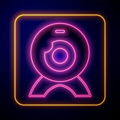 Poster - Glowing neon Web camera icon isolated on black background. Chat camera. Webcam icon. Vector