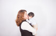 © artrolopzimages - Beautiful photo of loving mom with baby on light photo studio background. Family and baby concept.
