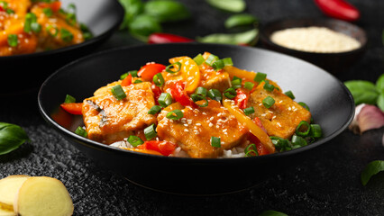 Wall Mural - Homemade Stir Fry Tofu with Vegetables and Rice in black bowl.