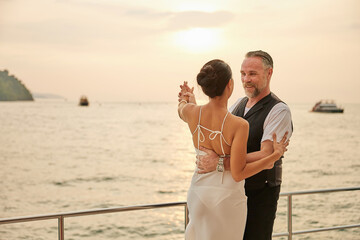 couple dancing on luxury yacht at the sea