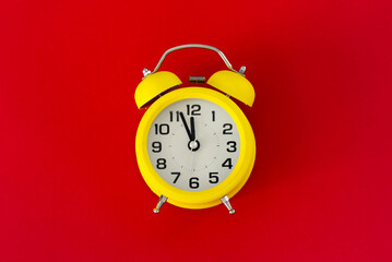 Wall Mural - Yellow  classic desktop clock the red  background