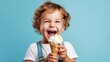 Cheerful kid eating ice cream in waffle cone isolated on blue. Generative AI.