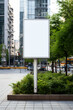 Blank white digital billboard poster on city street in the midday sun 
