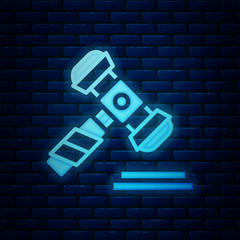 Wall Mural - Glowing neon Judge gavel icon isolated on brick wall background. Gavel for adjudication of sentences and bills, court, justice. Auction hammer. Vector