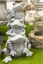 Funny Garden Sculptures. Decorations For The Garden Or Decoration Of The Exterior Of The House. 3 Concrete Frogs On Top Of Each Other With A Welcome Sign. Garden Care Concept.