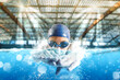 © alphaspirit - Sporty woman athlete swims with energy during a competition in the pool