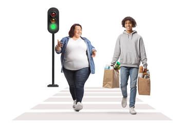 Canvas Print - Full length portrait of a caucasian overweight woman crossing street and talking to an african american guy