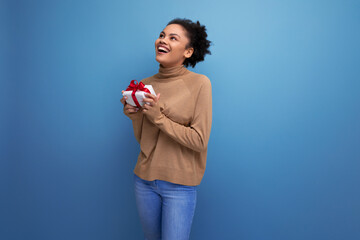 isolated background, cute young brunette hispanic woman with hairstyle received a gift for holiday birthday