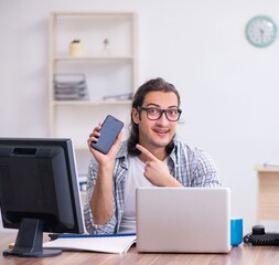 Young male it specialist working in the office