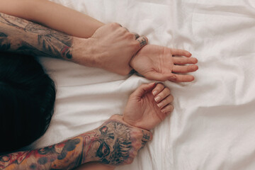 Wall Mural - passionate couple having sex on bed, closeup of hands