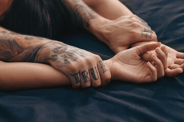 passionate couple having sex on bed, closeup of hands
