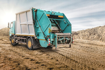 Fototapete - A large garbage truck brought the garbage to the quarry for temporary storage. Powerful modern technology for the city. Ecology. Separate collection and disposal of waste.