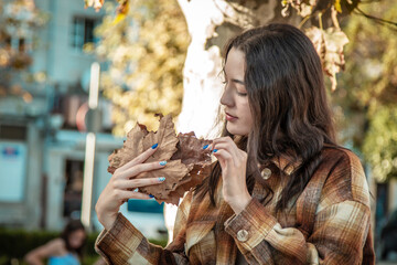 Wall Mural - girl in autumn with coat and autumn background