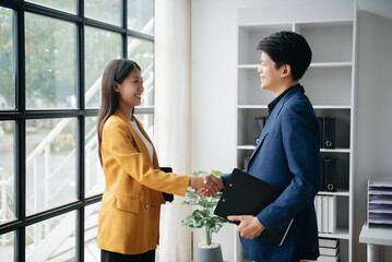 Two confident business man shaking hands during a meeting in the office, success, dealing, greeting and partner in sun light