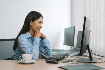 Wall Mural - asian woman software developers sitting in front of computers looking at computer codes on the scree