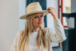 © Westend61 - Woman with long blond hair wearing hat