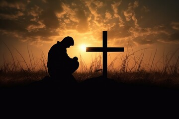 Silhouette of a man praying with a cross in the background