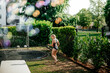 © Alena Vilgelm - Young girl plays near a fountain in a park on a warm sunny day, enjoying summer freedom.