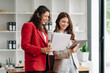 © Nuttapong punna - Two Asian businesswoman discuss investment project working and planning strategy with tablet laptop computer in office.