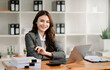 © Nuttapong punna - Woman freelancer is working her job on computer tablet and laptop Doing accounting analysis report real estate investment data, Financial at office.
