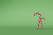 Christmas candy cane red and white festive sweet on a green background. 3D Rendering.