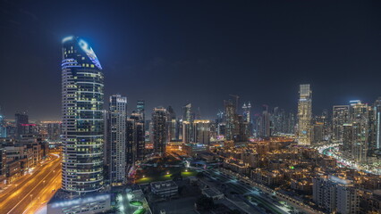  Panorama showing Dubai Downtown and business bay night timelapse with tallest skyscraper and other towers