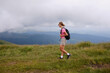 © KatyaPulka - Girl is watching on mountains view. Woman is hiking in mountains in summer.Beautiful mountain landscape in Carpathians, Romania.Travel and tourism.Woman hiker is enjoying the mountain view.