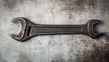 Two Crossed Dirty Wrenches On Grunge Background Top View