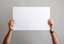 Hands Are Holding A Blank Sheet Of Paper With A White Background
