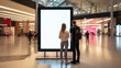 © sizsus - a couple man and a woman standing in-front of a big white mockup blank screen at a shopping mall or center - Generative AI