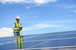© kokliang1981 - Engineer Inspector Quality in Solar Roof Panel Installation, Sustainable Photovoltaic Work for Factory Buildings. Natural Energy Sources Infrastructure Development in Efficiency.
